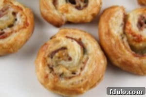Baked Prosciutto Gruyère Pinwheels, golden and flaky Crispy, golden Prosciutto Gruyère Pinwheels fresh out of the oven