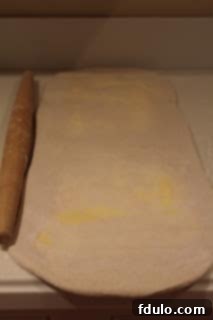 Homemade puff pastry during preparation for appetizer Second step of preparing homemade puff pastry, showing butter slightly breaking through