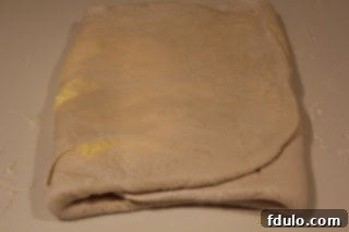 First turn of homemade puff pastry for pinwheel appetizers First fold or 'turn' in the process of making homemade puff pastry