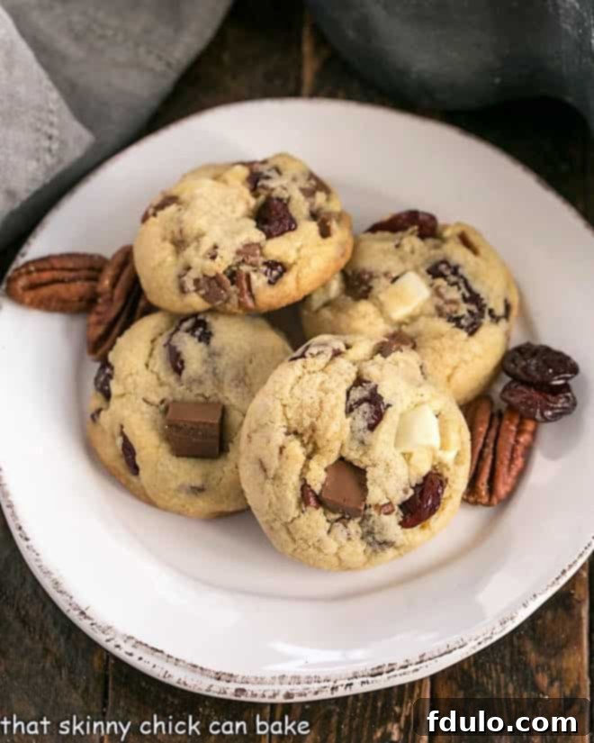Overhead view of Cherry Chocolate Chunk Cookies on a round white plate, showcasing their generous chunks of chocolate and dried cherries.