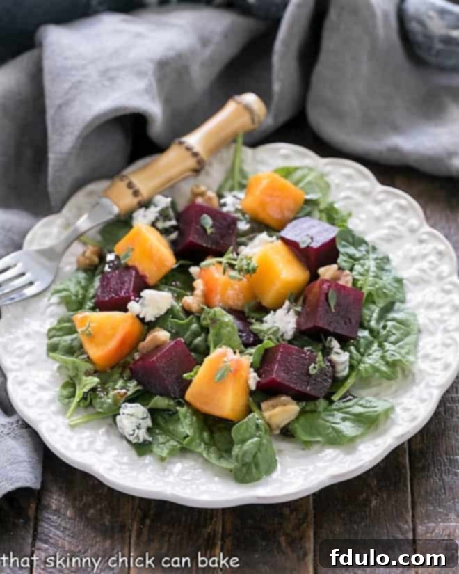 An elegant serving of Beet Salad, beautifully arranged on a decorative white plate, featuring a bamboo handle fork. This cold beet salad is a culinary artwork.