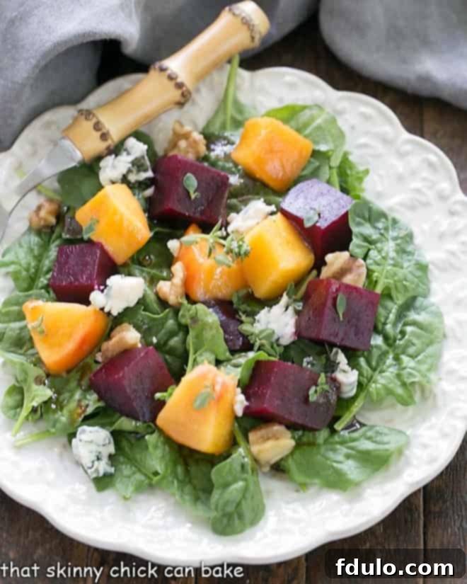 A close-up overhead view of the vibrant Peach and Beet Salad, showcasing the rich colors of the ingredients and the glistening flavorful beet salad dressing with honey and Dijon mustard.