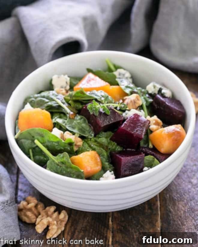 A vibrant Peach and Beet Salad in a white bowl, ready to be served. This is a beautiful summer salad.
