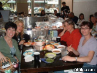 Four smiling sisters enjoying a meal at a sushi bar in Seattle, capturing a moment of family bonding.