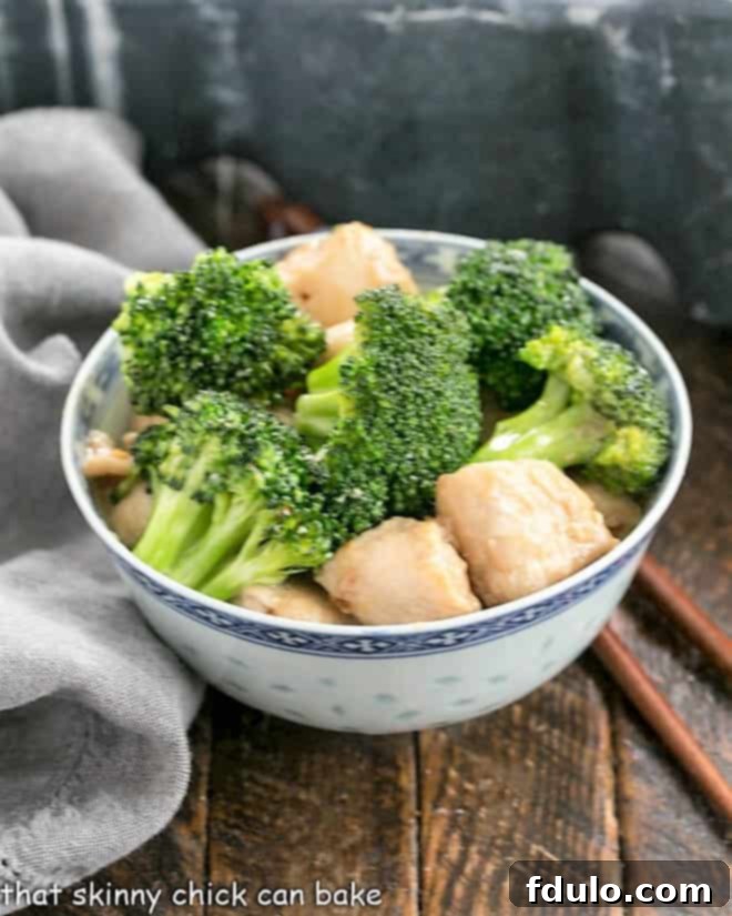 Broccoli and Chicken Stir Fry in a blue and white ceramic bowl