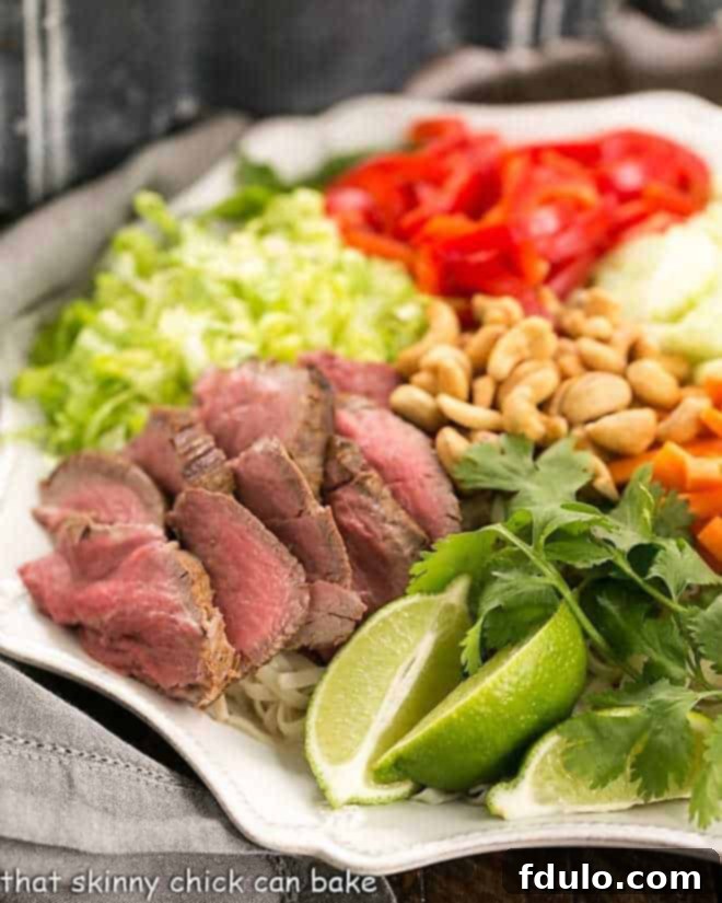 Half of a Vietnamese Beef Noodle Bowl on a white platter.