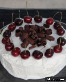 Close-up of Black Forest Cherry Cake with cream and cherries