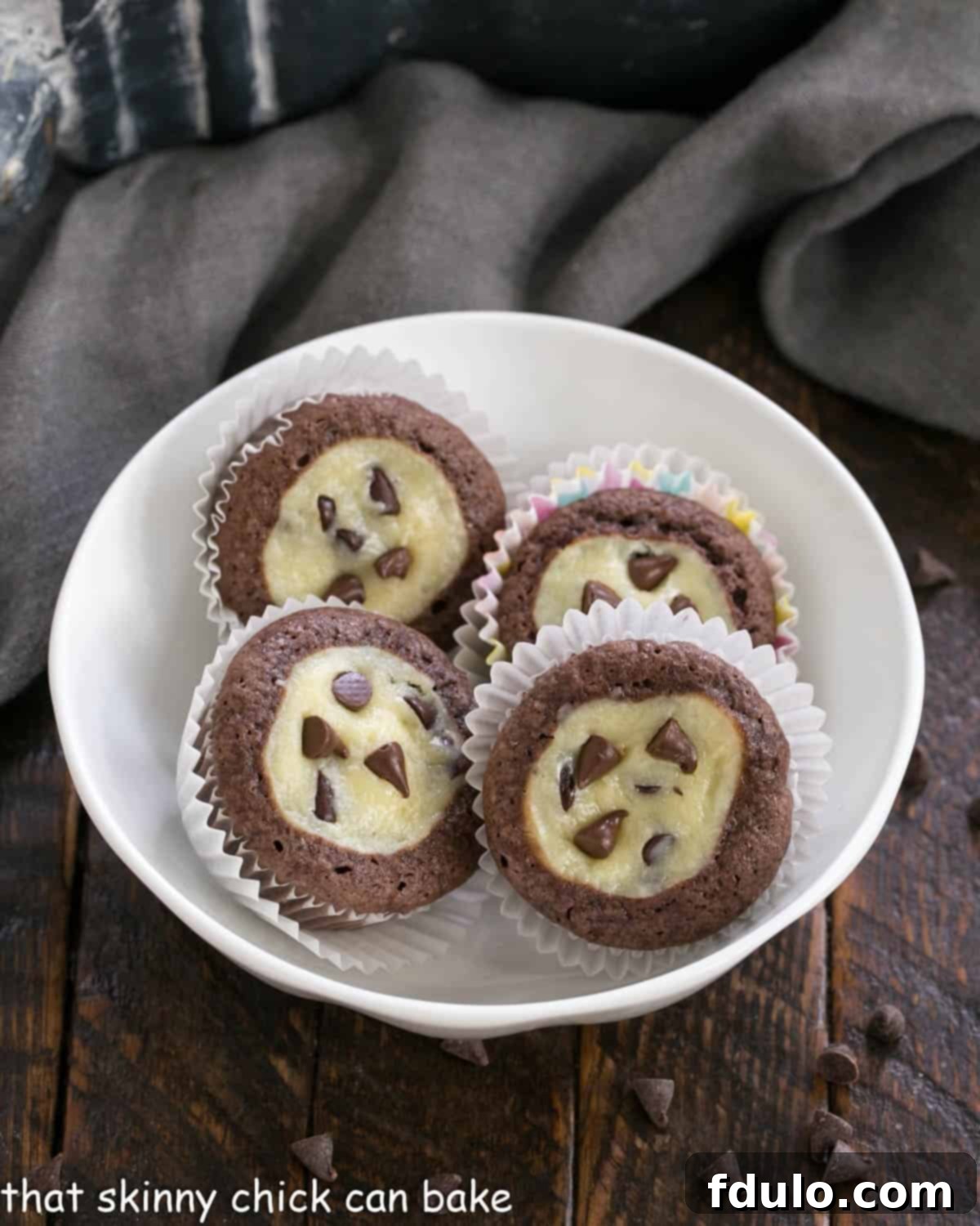 Mini chocolate cupcakes in a white bowl, showcasing their perfect size and inviting texture.