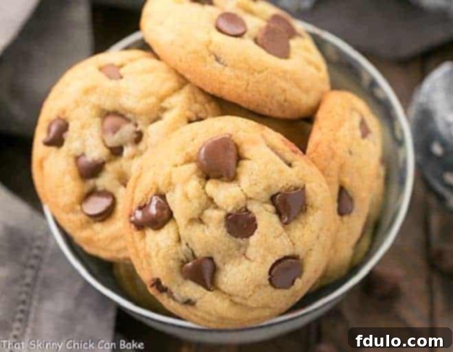 A captivating close-up of freshly baked double chocolate chip cookies, showcasing their chewy texture, perfectly melted chocolate chips, and tempting golden-brown edges.