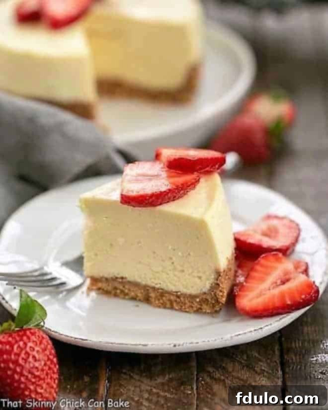 A perfectly portioned slice of Vanilla Bean Instant Pot Cheesecake on a charming dessert plate, highlighting its creamy interior and distinct crust.