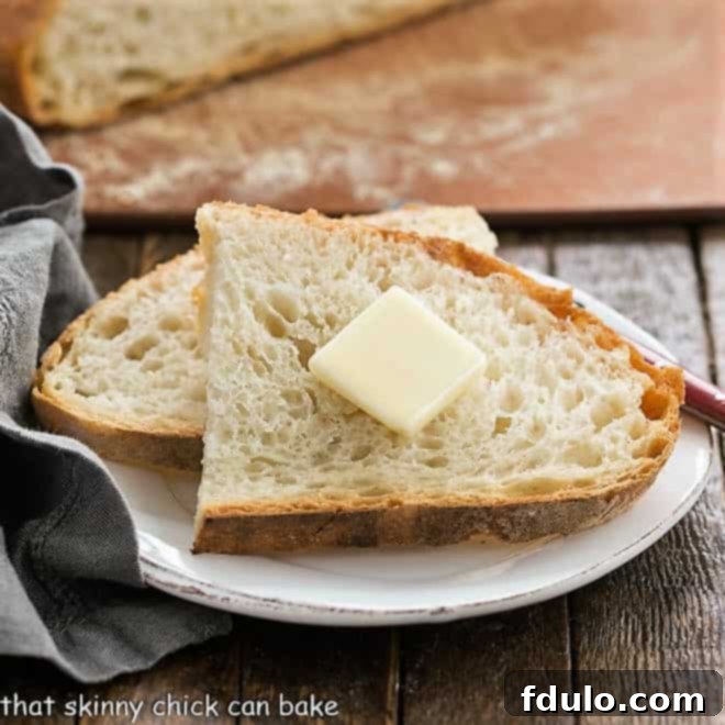 No-Knead Bread Recipe slices on a small white plate, ready to be enjoyed.