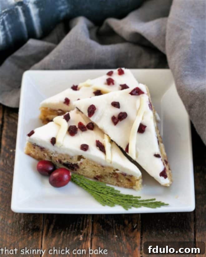 3 cranberry bars on a square white plate