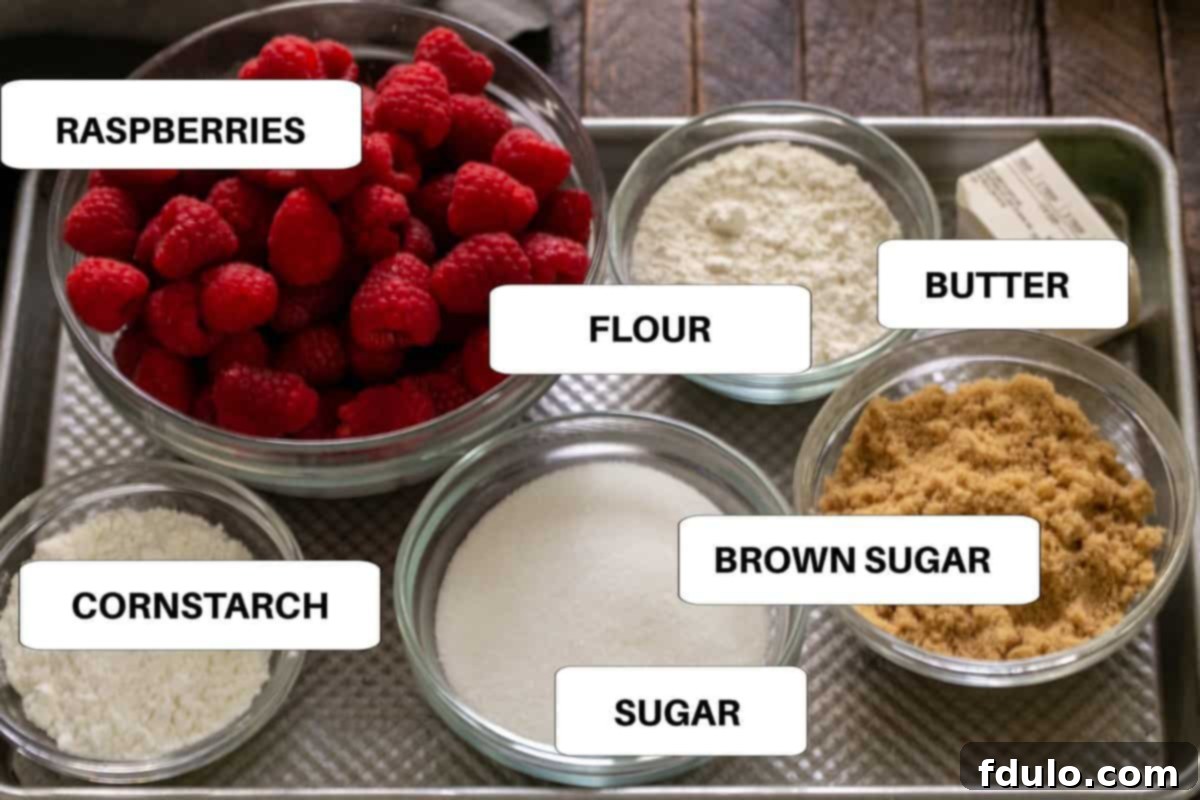 Labeled ingredients for an easy raspberry crisp displayed neatly on a metal sheet pan, ready for preparation.
