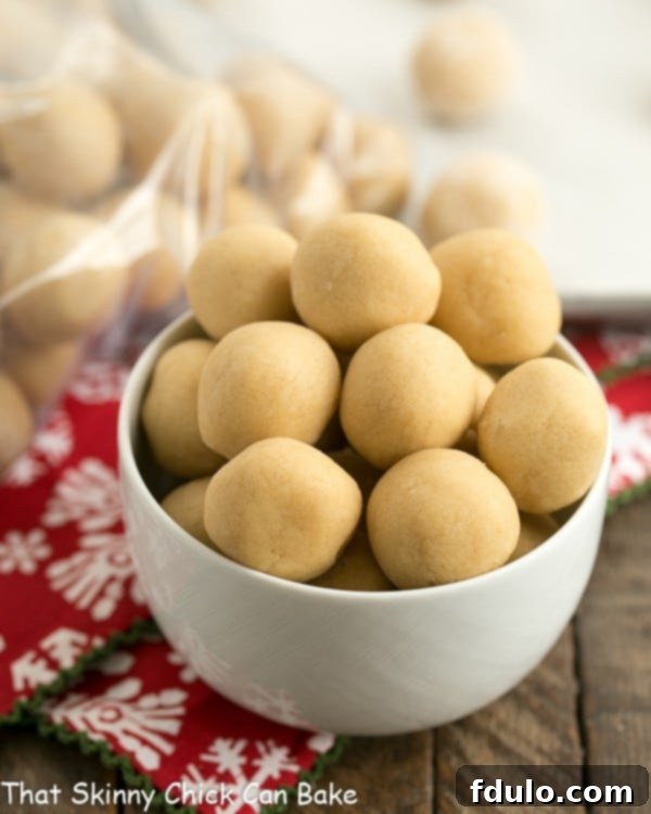 A bowl full of cookie dough balls ready for freezing