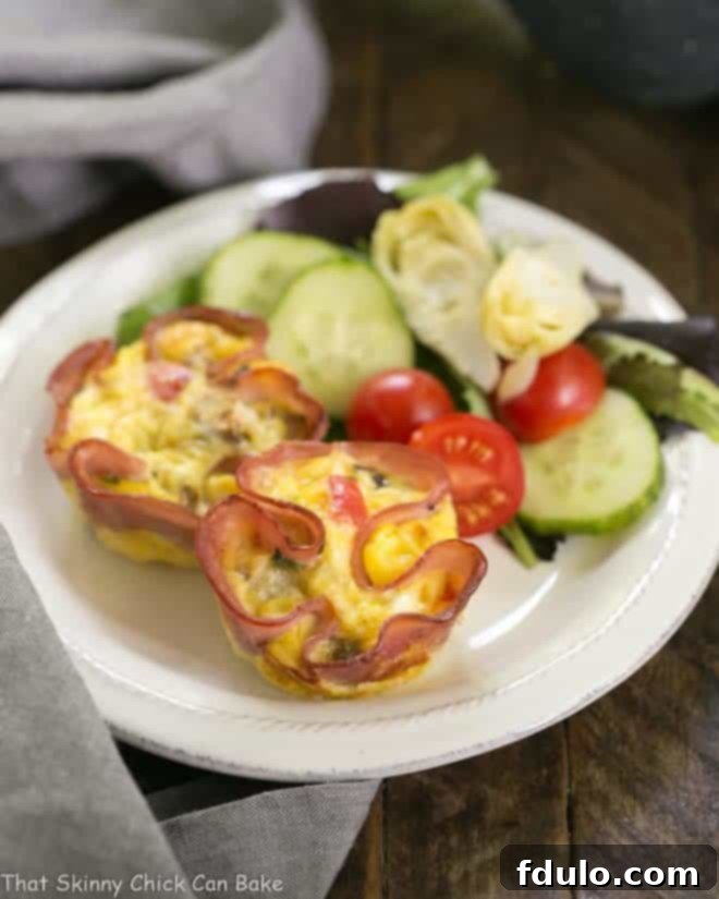 Egg Muffins in Ham Cups with a green salad on a small white plate, ready to be served.