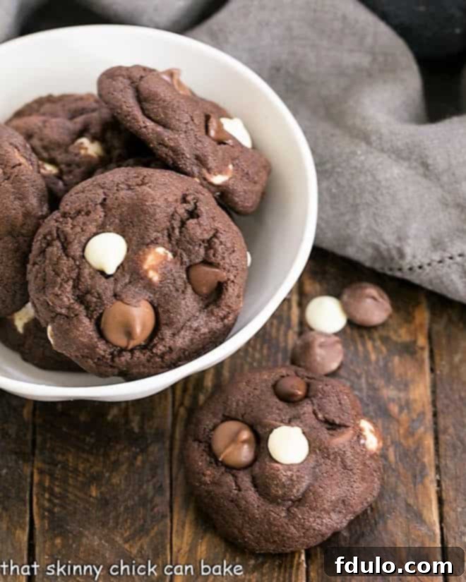 Decadent Four-Chocolate Cookies 8 Overhead with of a bowl of Quadruple Chocolate Cookies with one cookie removed.