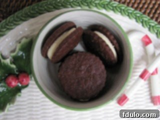 Rich Chocolate Sandwich Cookies 4 Chocolate sandwich cookies neatly arranged, showcasing their perfect round shape and generous white chocolate ganache