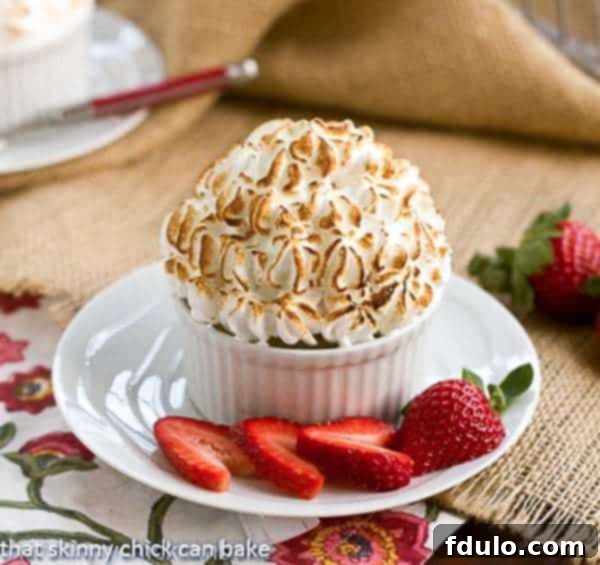 Individual Baked Alaska in a ramekin on a white saucer