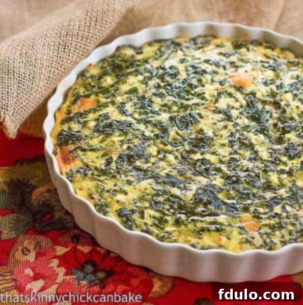 Classic Cheesy Spinach Soufflé in a white casserole dish, ready to serve.