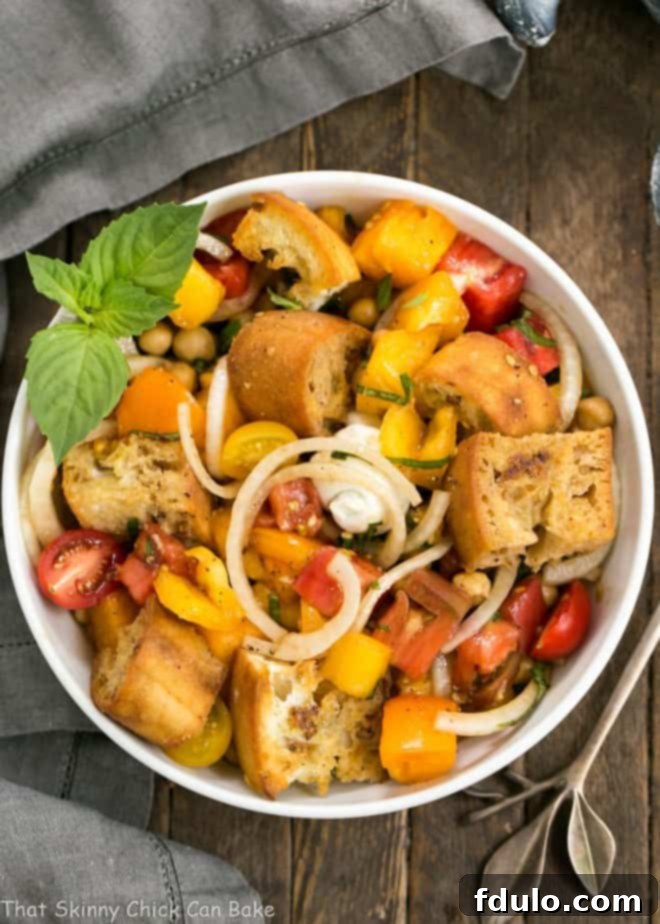 Close-up of Summer Tomato and Burrata Panzanella Salad, highlighting fresh tomatoes, creamy burrata, and toasted bread cubes.