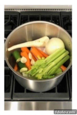 Add chopped vegetables and aromatics to the pot with chicken.