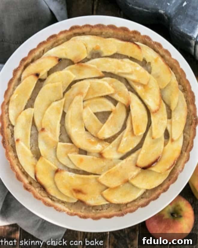 Overhead view of a perfectly baked French Apple Tart with a decorative apple swirl