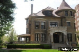 A grand, historic brick building with intricate architectural details, set against a clear sky.