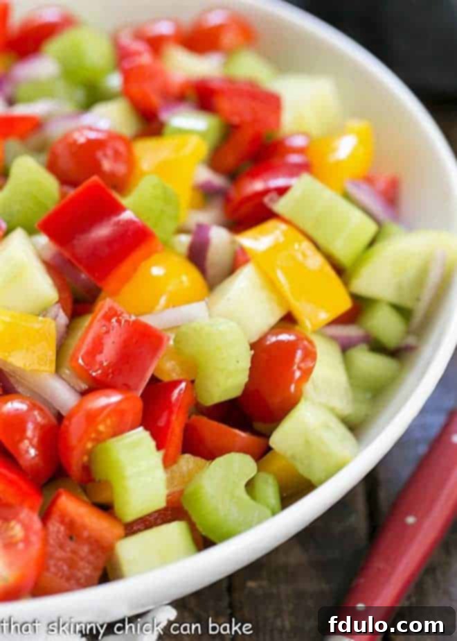Close-up view of fresh, vibrant vegetables marinating in a bowl, showcasing their texture.