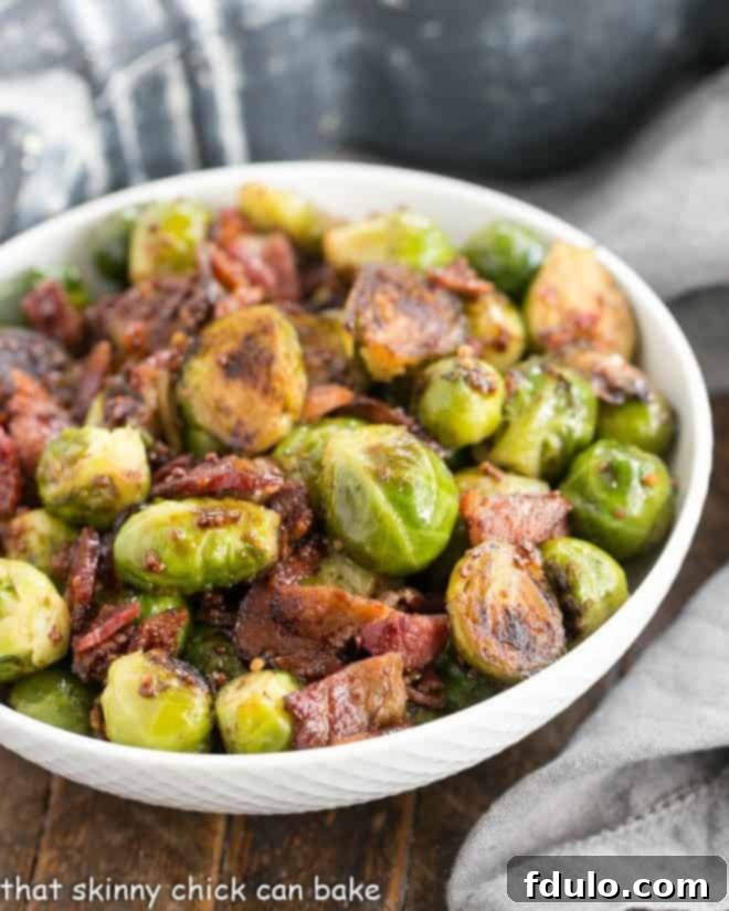 A serving of Maple Syrup Mustard Glazed Brussels Sprouts in a round white ceramic bowl, ready to be enjoyed as a festive side dish.