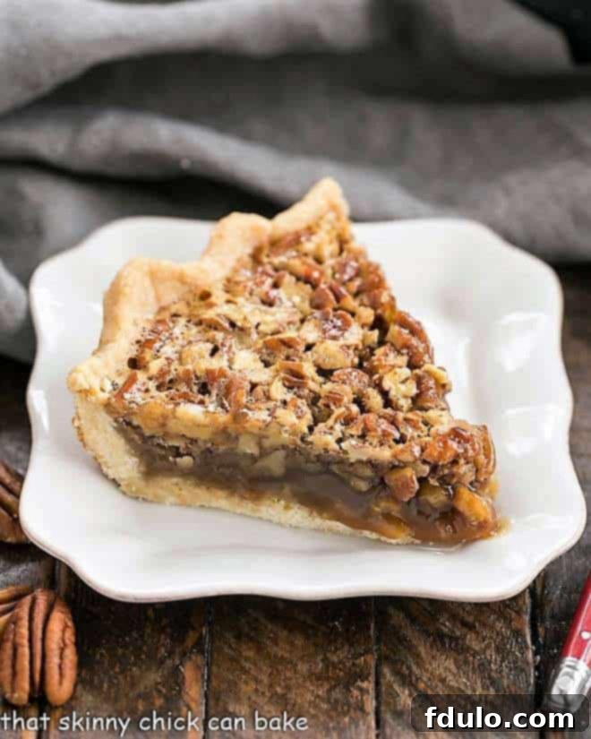 Classic Pecan Pie slice on a square white plate.