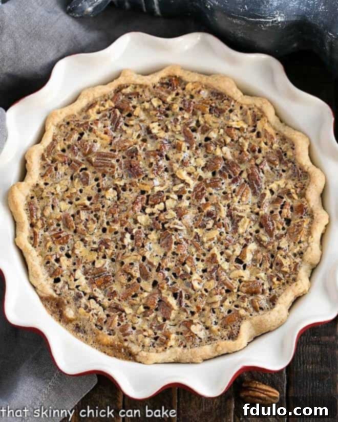 Classic Pecan Pie in a red pie plate overhead view