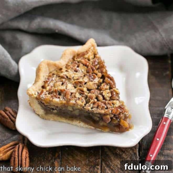 Classic Pecan Pie slice with a red handled fork