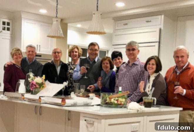 Friends enjoying salad tossed with balsamic vinaigrette Friends gathered in a brightly lit kitchen, enjoying an impromptu party with salad and pizza.