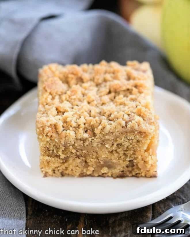 Multiple slices of Apple Streusel Coffee Cake arranged on a white ceramic plate, ready for serving.