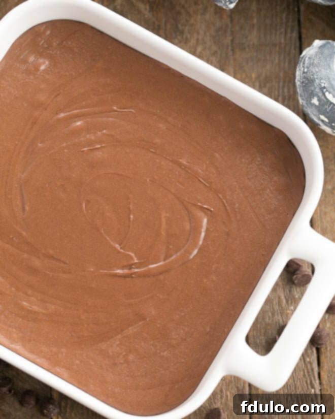 No-Fail Chocolate Fudge in a square dish, showcasing its smooth texture.