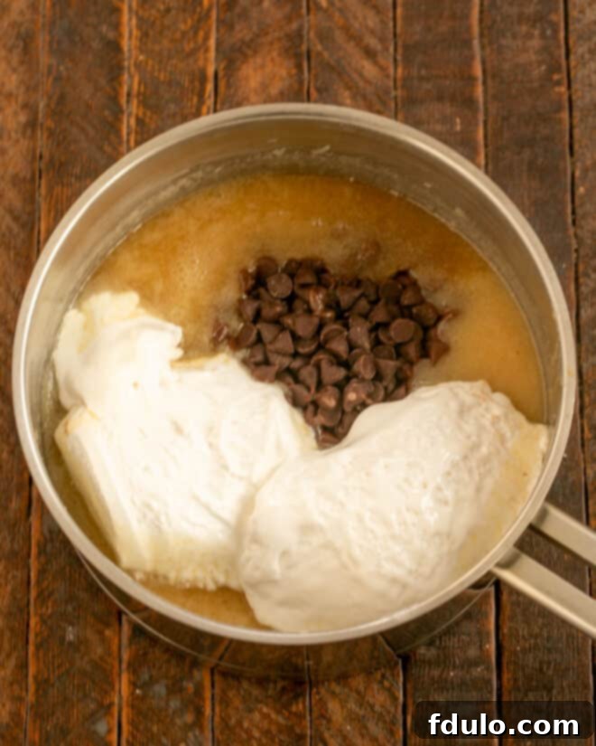 Adding marshmallow creme, chocolate chips, and vanilla to the hot fudge mixture.