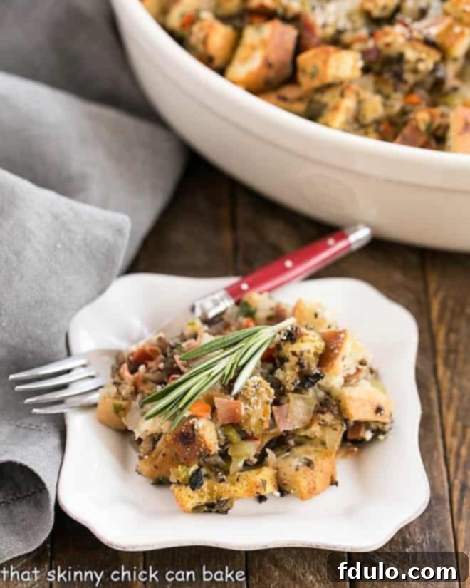 Pancetta Ciabatta Dressing served on a small plate, ready to be enjoyed with a red-handled fork.
