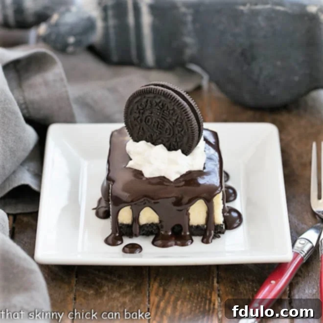 Hot Fudge Cheesecake Bars on a small white plate, ready to be enjoyed.