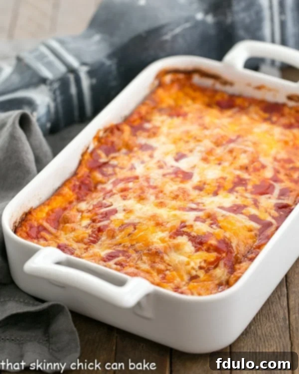 Chiles Rellenos casserole is a super simple Tex-Mex dish that is pure comfort food! This Easy Chiles Rellenos casserole recipe makes an easy weeknight dinner. A white casserole dish filled with baked Chiles Rellenos Casserole, ready to serve.