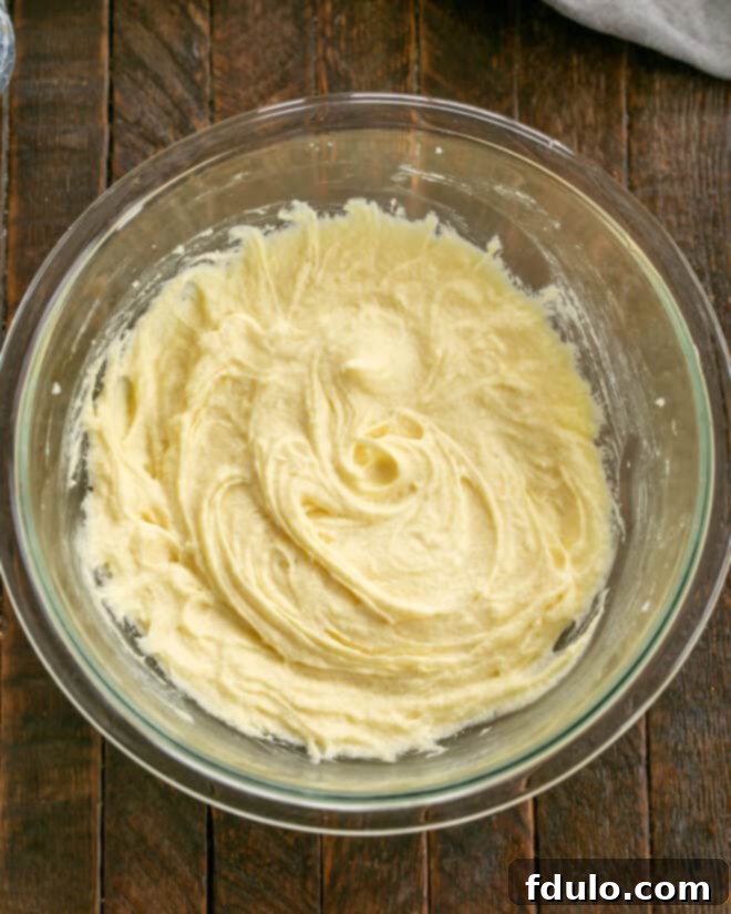 White Chocolate-Kissed Red Velvet Brownies 5 Sugar, butter, eggs mixed in bowl.