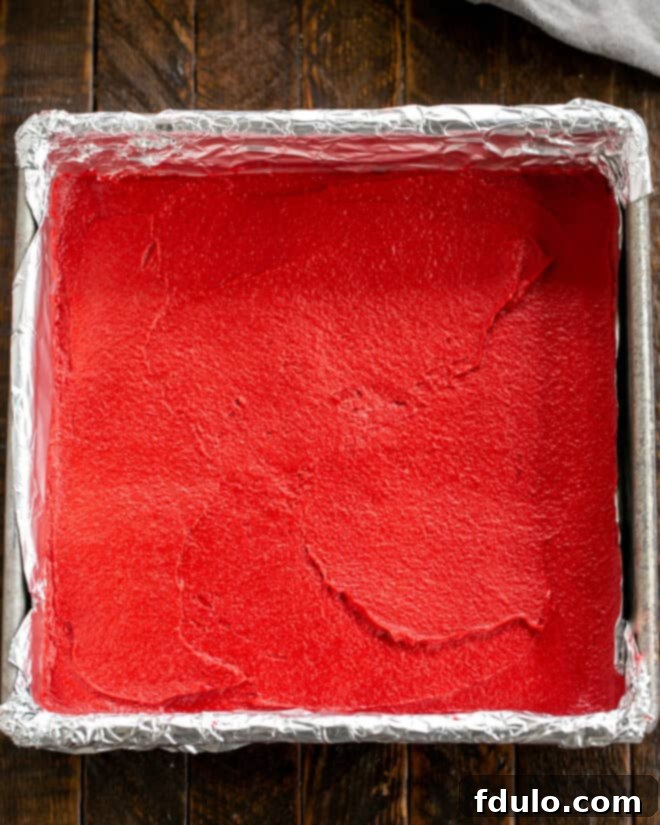 White Chocolate-Kissed Red Velvet Brownies 7 Batter spread into baking pan.