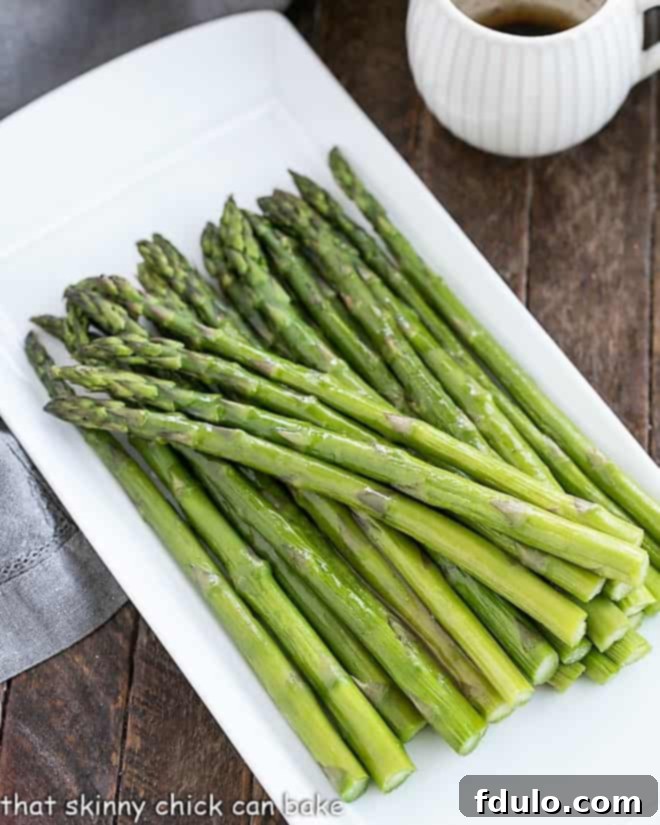 Roasted Asparagus with Balsamic Brown Butter on a white platter, ready to be served.