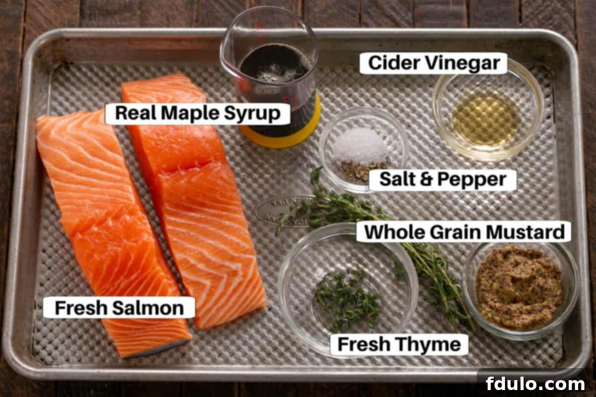 All ingredients for Maple Mustard Salmon laid out on a sheet pan, ready for preparation.