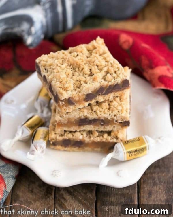 A white dessert plate with a stack of three freshly baked Oatmeal Caramel Bars, showing off the golden oat layers and the rich caramel filling.