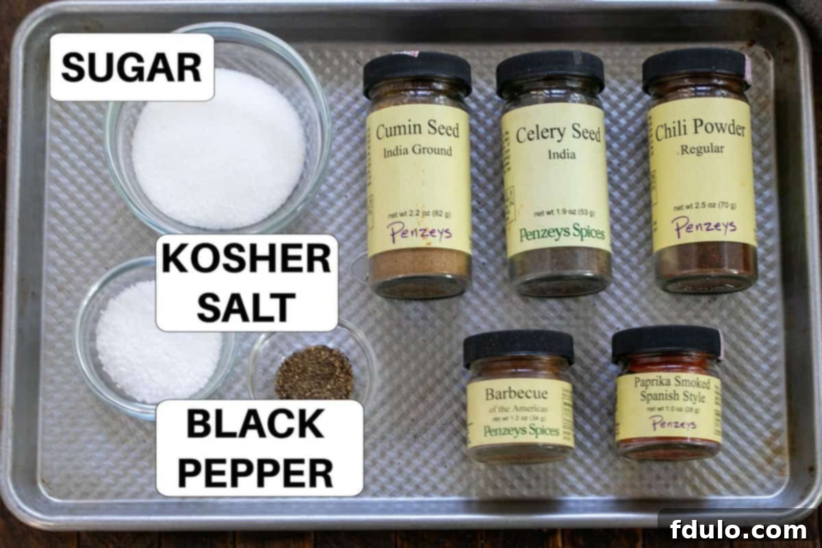 Labeled Baby Back Ribs Rub ingredients displayed on a sheet pan, ready for mixing.