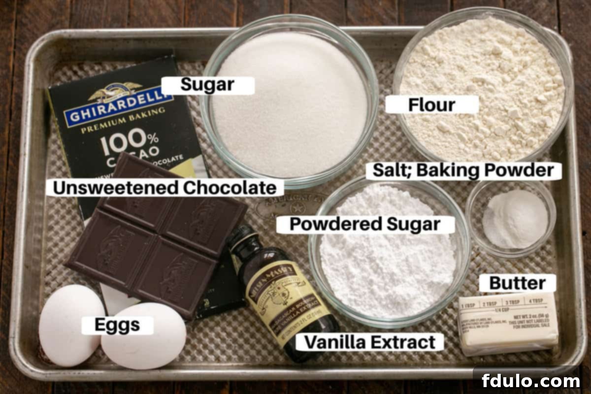 Collection of carefully measured ingredients for chocolate earthquake cookies with individual labels, neatly arranged on a sheet pan.