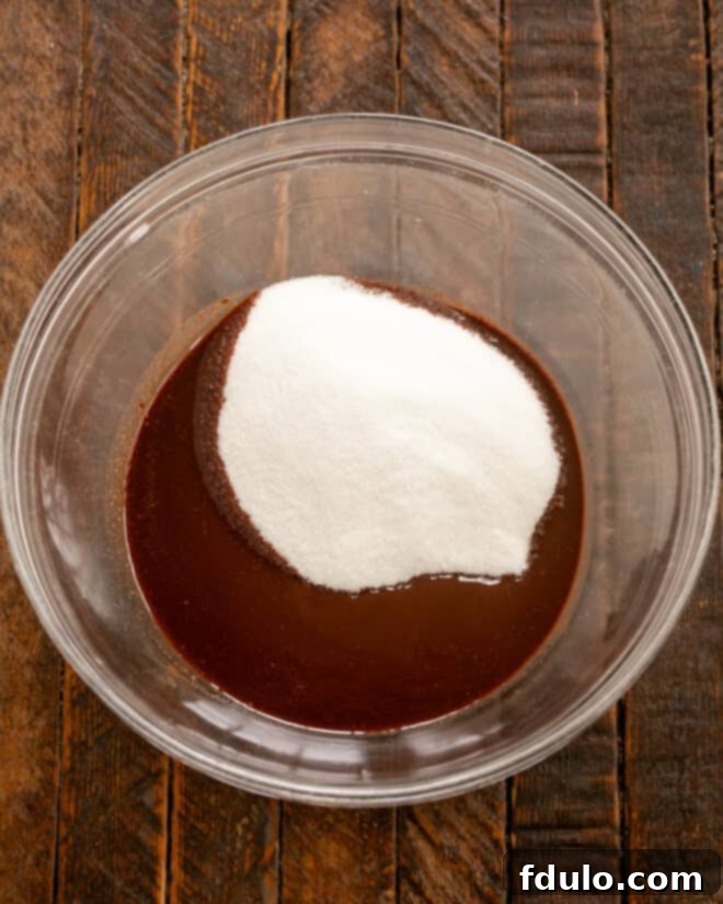 Step 2: Add granulated sugar to the melted butter and chocolate mixture.