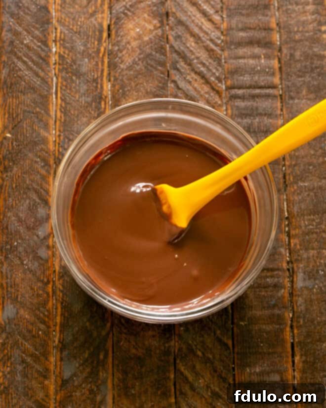 Step 5: Gently melting chocolate and vegetable oil together in a bowl until smooth and glossy.