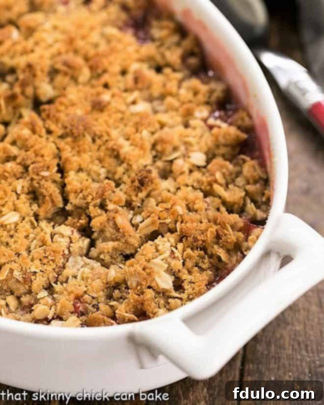 Close view of rhubarb crisp topping, showing the golden oats and buttery crumbs.