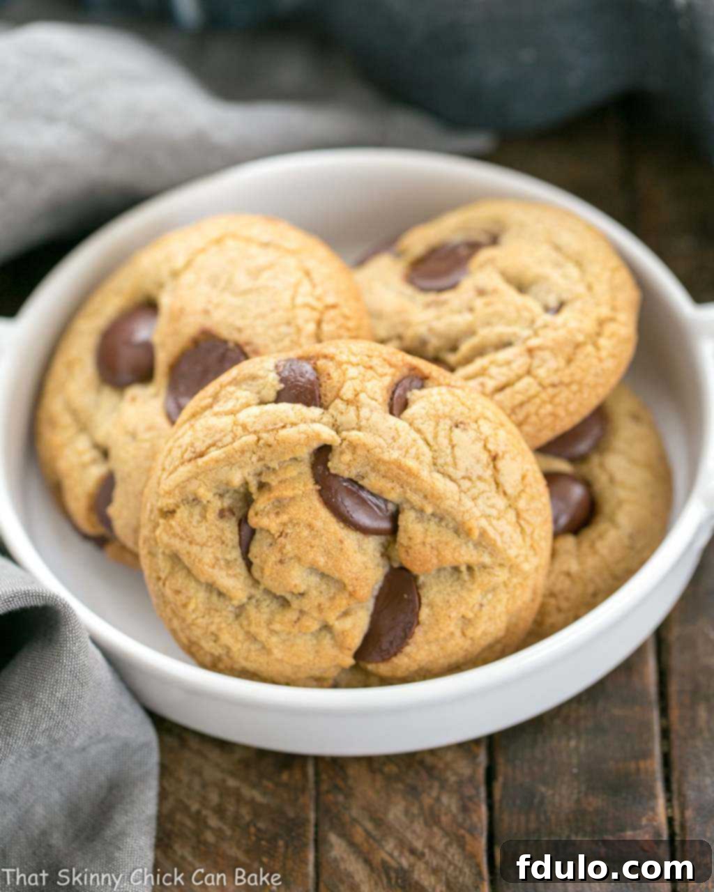 Brown Butter Chocolate Chip Cookies - with a boost of deliciousness from nutty brown butter and dark brown sugar! Irresistible Brown Butter Chocolate Chip Cookies showcased in an elegant white ceramic dish, ready to be enjoyed.